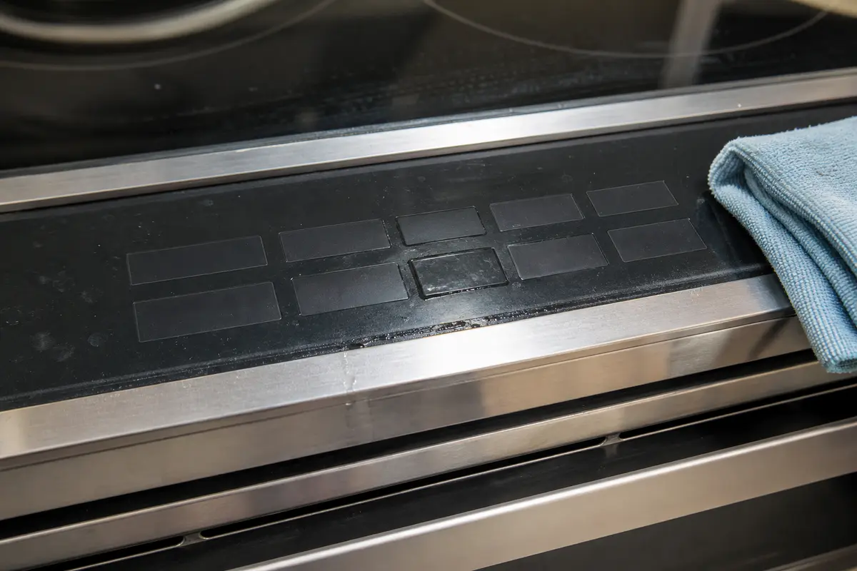 Range keypad close-up with cleaner residue and a lower touch area near the control seam