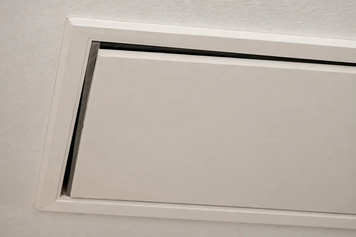 Attic hatch with an uneven gap and missing compression at the weatherstripping