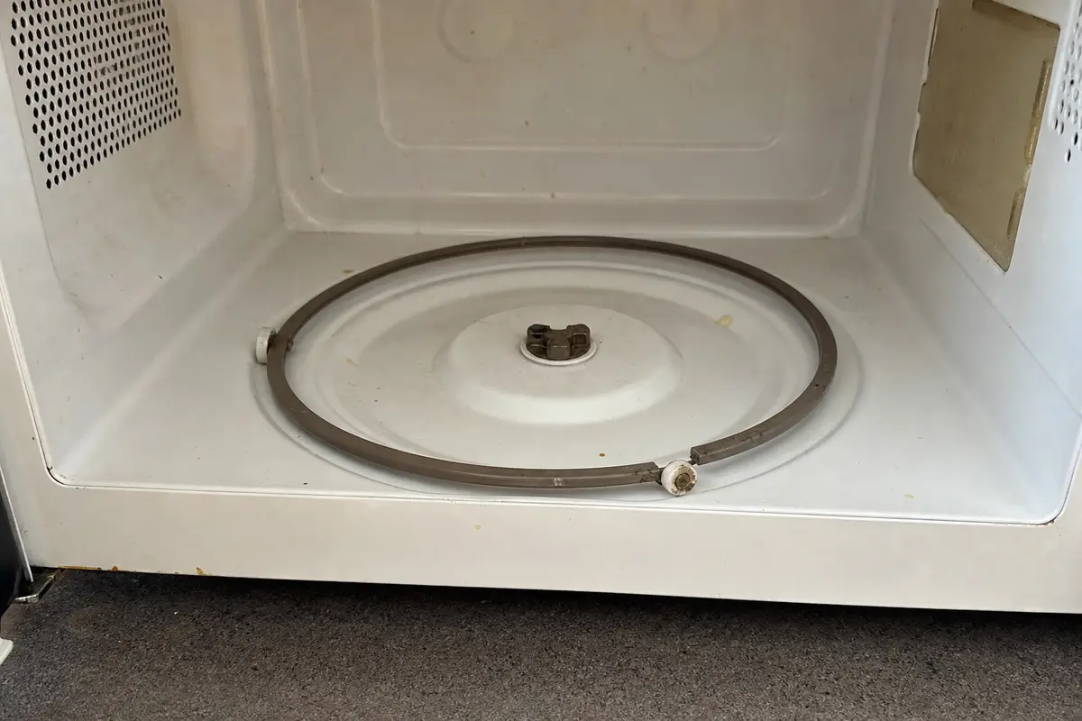 Cracked microwave roller ring wheel and support frame before replacement