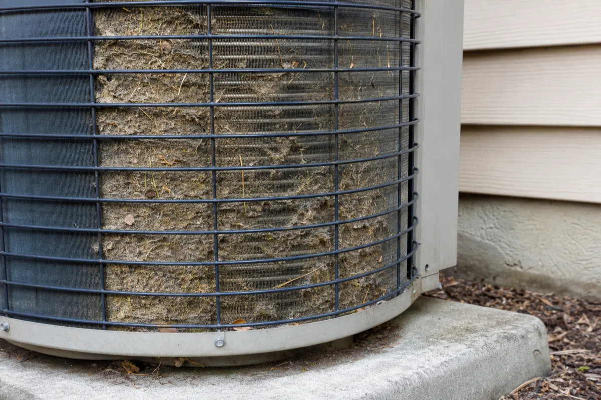 Dirty outdoor condenser coil that can contribute to AC breaker trips in afternoon