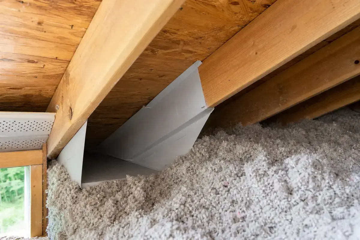 Attic ventilation baffle preserving soffit intake near insulation