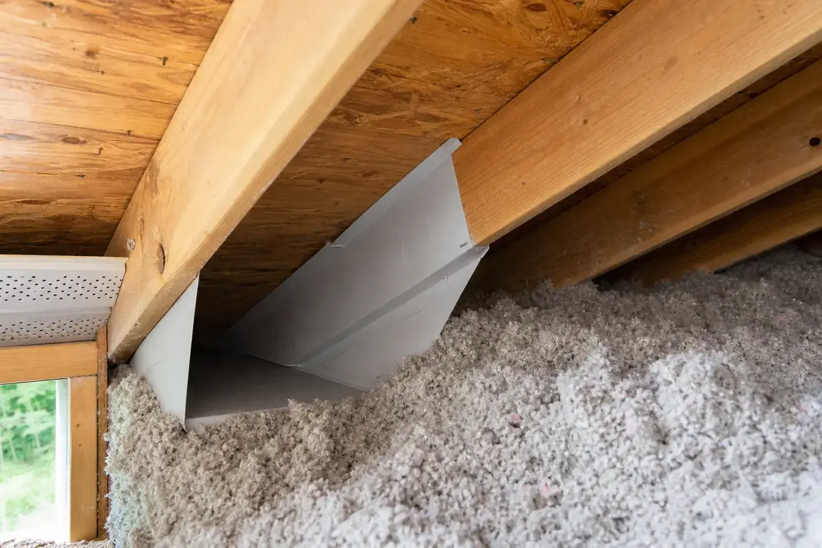 Attic ventilation baffle keeping soffit intake open near high humidity