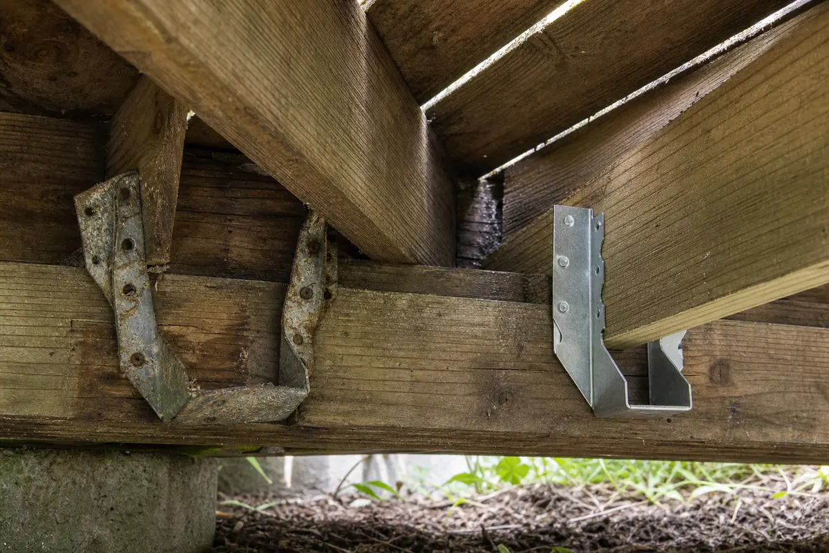 Galvanized deck joist hanger for a confirmed connector repair