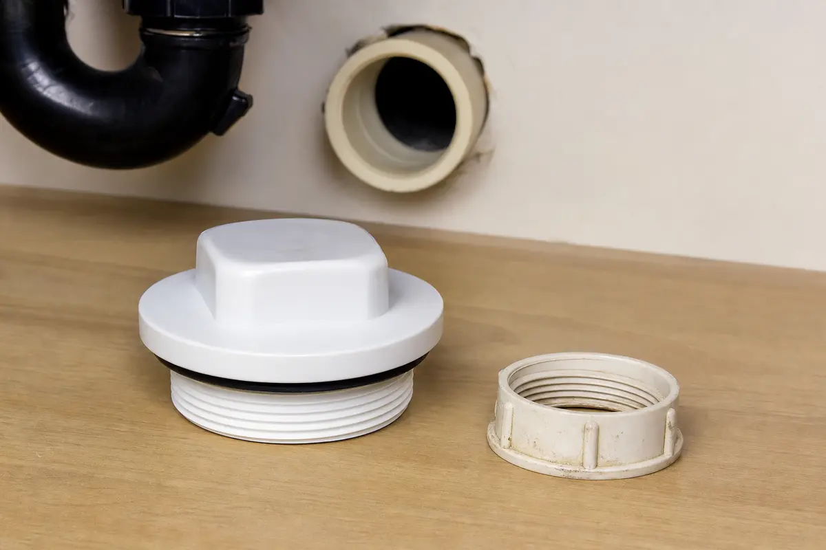 Drain cleanout cap for a kitchen sink drain repair