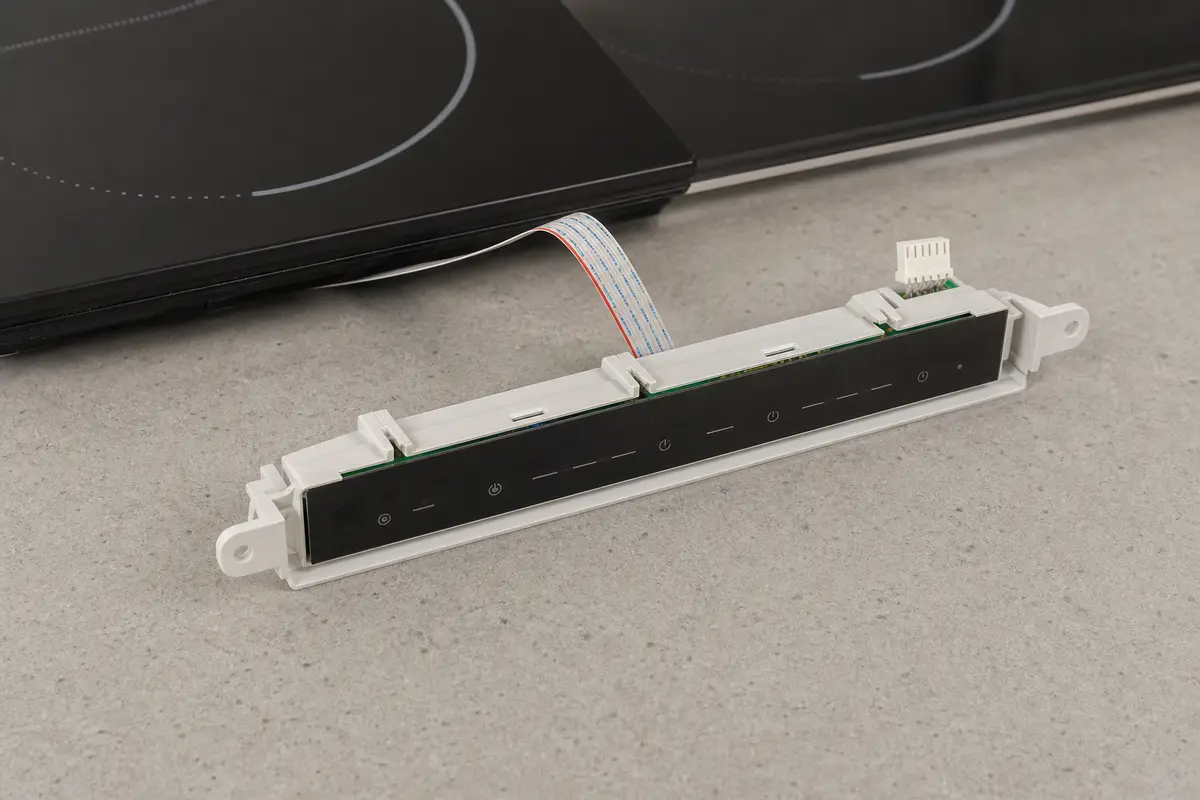 Cooktop control switch part staged for model-number comparison