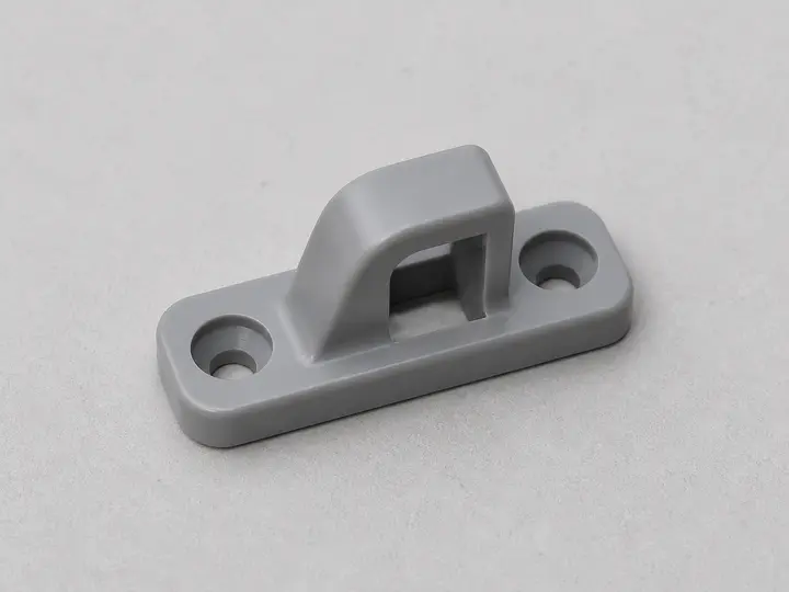 Gray washer door strike with mounting holes
