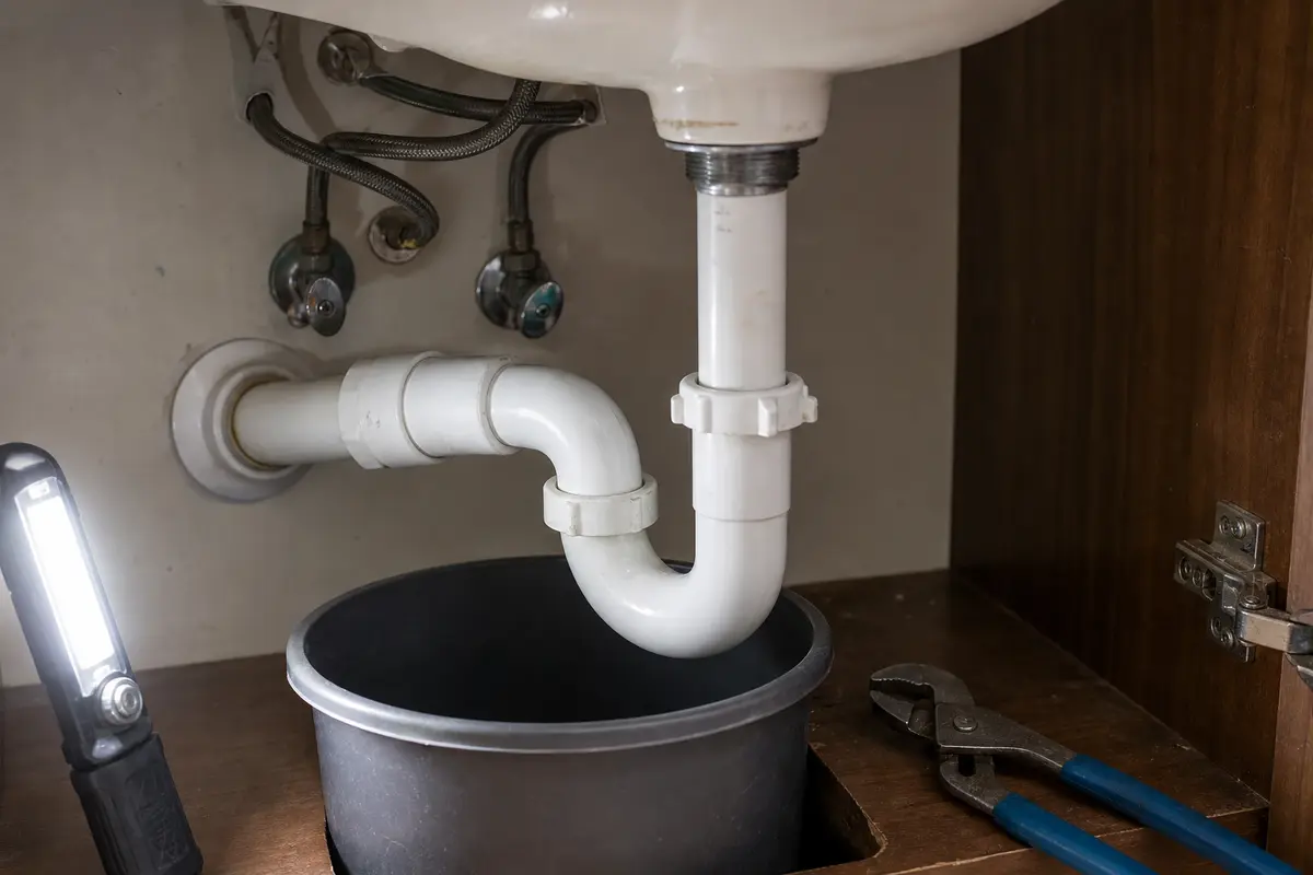 Under sink P-trap check with bucket for one drain gurgling after heavy rain