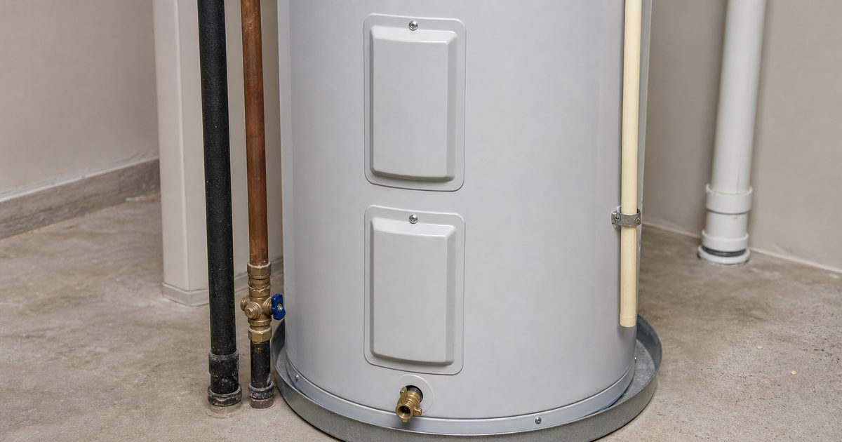 Residential electric tank water heater with access panels and drain valve visible