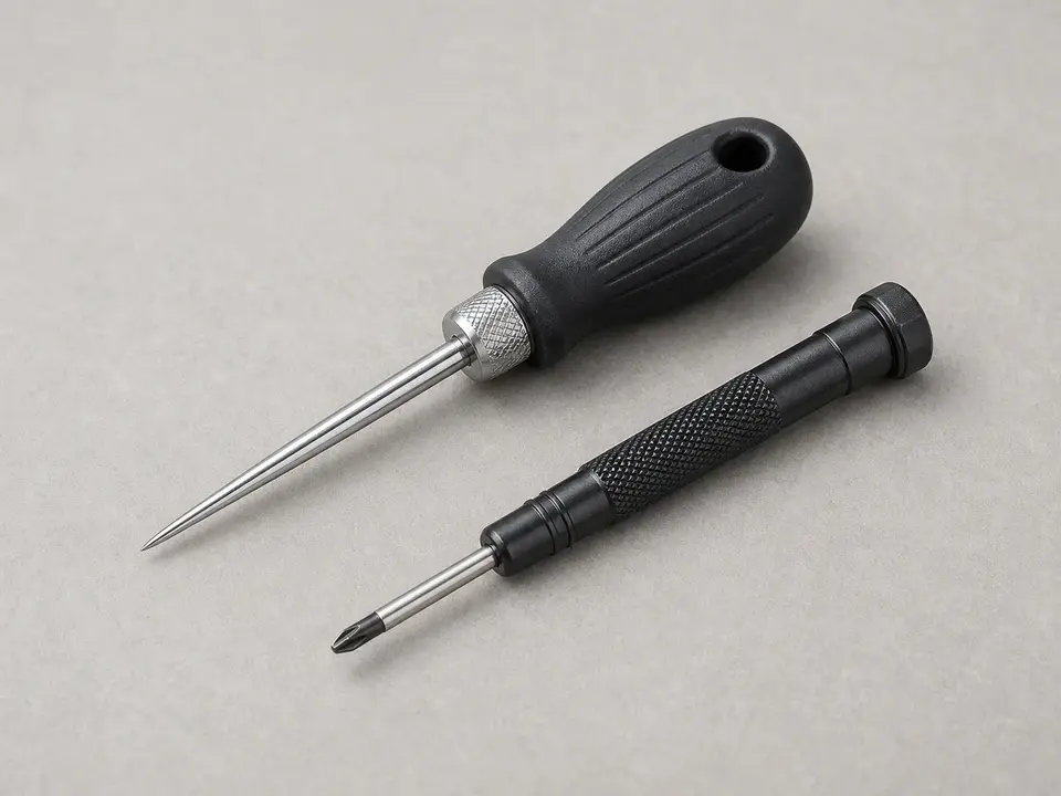 Nozzle cleaning pin for clearing debris from a pressure washer spray tip