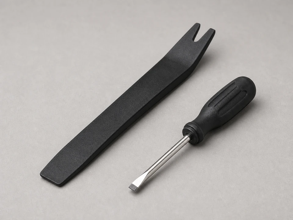 Small flat screwdriver or plastic pry tool tool