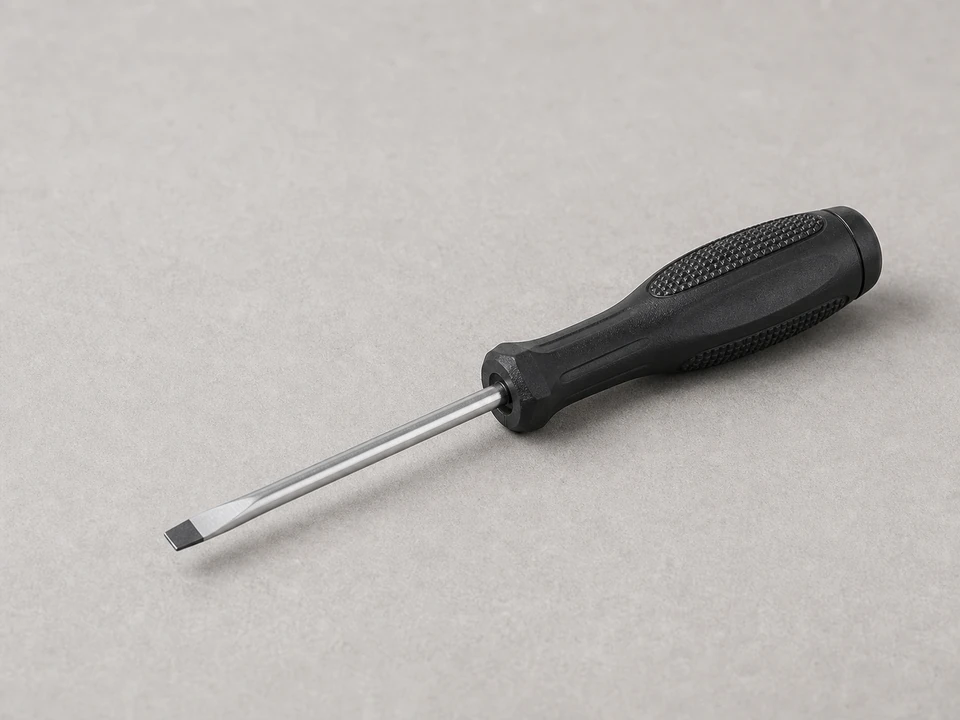 Small flat screwdriver for releasing a thermostat battery door tab