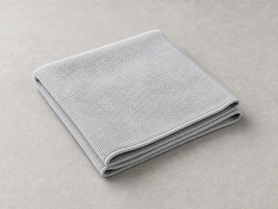 Soft cloth for wiping dust from a thermostat battery compartment