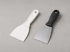 Caulk scraper or putty knife tool