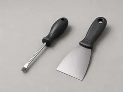 Putty knife or thin flat screwdriver tool